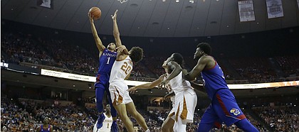 Kansas guard Devon Dotson (1) shoots over Texas forward Jericho Sims (20) during the first half of an NCAA college basketball game, Saturday, Jan. 18, 2020, in Austin, Texas. (AP Photo/Eric Gay)