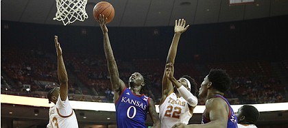Kansas guard Marcus Garrett (0) shoots past Texas forward Kai Jones (22) during the first half of an NCAA college basketball game, Saturday, Jan. 18, 2020, in Austin, Texas. (AP Photo/Eric Gay)