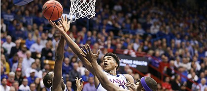 Kansas guard Ochai Agbaji (30) lunges to the bucket between Kansas State forward Montavious Murphy (23) and Kansas State forward Makol Mawien (14) during the first half, Tuesday, Jan. 21, 2020 at Allen Fieldhouse.