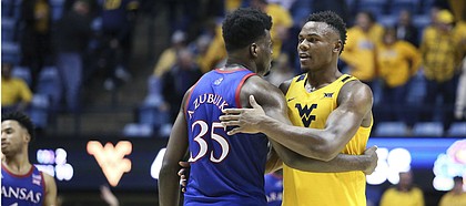 Kansas center Udoka Azubuike (35) and West Virginia forward Oscar Tshiebwe (34) greet each other after an NCAA college basketball game Wednesday, Feb. 12, 2020, in Morgantown, W.Va. (AP Photo/Kathleen Batten)