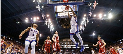 Kansas center Udoka Azubuike (35) delivers a dunk after a lob from Kansas guard Devon Dotson (1) during the first half on Saturday, Feb. 15, 2020 at Allen Fieldhouse.
