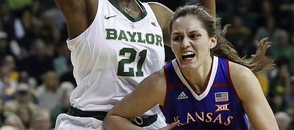 Baylor center Kalani Brown (21) defends as Kansas forward Mariane de Carvalho (4) drives to the basket during the first half of an NCAA college basketball game in Waco, Texas, Wednesday, Feb. 20, 2019. (AP Photo/Tony Gutierrez)