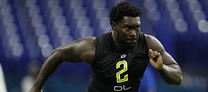 Kansas offensive lineman Hakeem Adeniji runs a drill at the NFL football scouting combine in Indianapolis, Friday, Feb. 28, 2020. (AP Photo/Charlie Neibergall)