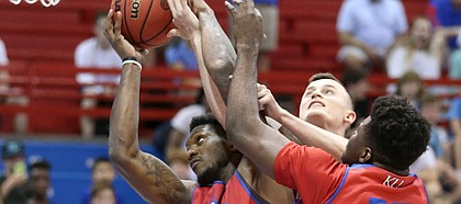 Kansas forward Silvio De Sousa battles for a rebound with Kansas forward Mitch Lightfoot and Kansas center Udoka Azubuike (35) during a scrimmage on Tuesday, June 11, 2019 at Allen Fieldhouse. In back is Kansas guard Ochai Agbaji (30).