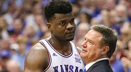 Kansas center Udoka Azubuike (35) hugs Kansas head coach Bill Self after coming out of the game with seconds remaining in regulation, Wednesday, March 5, 2020 at Allen Fieldhouse.
