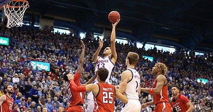 Kansas guard Tristan Enaruna (13) turns for a bucket over the Texas Tech defense during the first half, Saturday, Feb. 1, 2020 at Allen Fieldhouse.