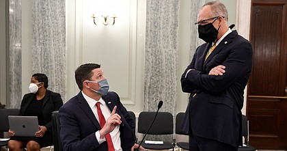 University of Mississippi Vice Chancellor for Intercollegiate Athletics Keith Carter, left, talks with Southeastern Conference Commissioner Greg Sankey, right, before they testify at a Senate Commerce Committee hearing on Capitol Hill in Washington, Wednesday, July 1, 2020. The hearing is looking at the National Collegiate Athletic Association Board of Governors' recent report on student-athlete compensation and the modernization of rules related to name, image, and likeness (NIL) commercialization.