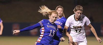 Ceri Holland fires in a cross against Iowa Saturday night at Rock Chalk Park on Nov. 16, 2019.