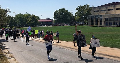 Kansas basketball junior Emma Merriweather led the pack during Friday's march, which came about when Merriweather and her teammates met Thursday to talk about what they could do to fight for social justice.