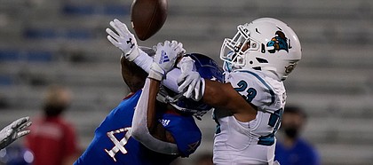 Coastal Carolina cornerback Derick Bush (23) is called for pass interference against Kansas wide receiver Andrew Parchment (4) during the second half of an NCAA college football game in Lawrence, Kan., Saturday, Sept. 12, 2020. Coastal Carolina defeated Kansas 38-23. (AP Photo/Orlin Wagner)