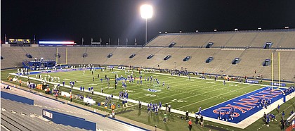 Kansas and Coastal Carolina warm up under the lights on Saturday, Sept. 12, 2020. The game was the season opener for both teams and, with fans not allowed to attend, it featured very few of the normal sights and sounds surrounding David Booth Kansas Memorial Stadium.