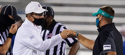 Kansas head coach Les Miles, left, greets Coastal Carolina head coach Jamey Chadwell before an NCAA college football game in Lawrence, Kan., Saturday, Sept. 12, 2020. (AP Photo/Orlin Wagner)