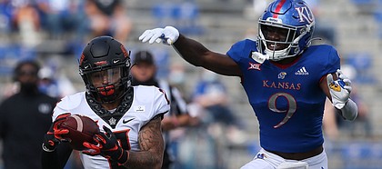 Oklahoma State's Tylan Wallace hauls in a deep pass just beyond the reach of KU cornerback Karon Prunty during the Jayhawks' 47-7 loss to OSU on Saturday, Oct. 3, 2020 at David Booth Kansas Memorial Stadium.