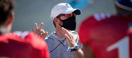 Kansas football offensive coordinator and quarterbacks coach Brent Dearmon addresses players during a preseason practice in August of 2020.
