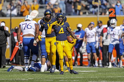 Oct 17, 2020; Morgantown, West Virginia, USA; West Virginia Mountaineers safety Alonzo Addae (4) celebrates after making an interception during the first quarter against the Kansas Jayhawks at Mountaineer Field at Milan Puskar Stadium.