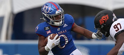 Kansas Jayhawks running back Velton Gardner (0) tries to stiff arm Oklahoma State Cowboys defensive tackle Amadou Fofana (97) during a run in the fourth quarter of a Big 12 football game between the Oklahoma State Cowboys and Kansas Jayhawks on October 3, 2020 at Memorial Stadium in Lawrence, KS. (Photo by Scott Winters/Icon Sportswire)