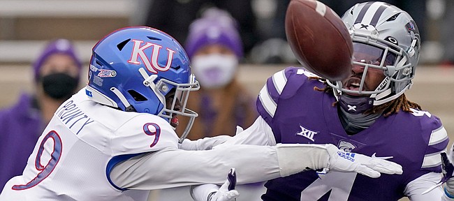 Kansas cornerback Karon Prunty (9) breaks up a pass intended for Kansas State wide receiver Malik Knowles (4) during the first half of an NCAA football game Saturday, Oct. 24, 2020, in Manhattan, Kan. (AP Photo/Charlie Riedel)