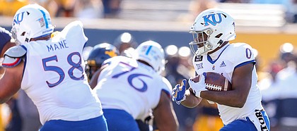 Kansas Jayhawks running back Velton Gardner (0) runs the ball during the third quarter against the West Virginia Mountaineers at Mountaineer Field at Milan Puskar Stadium.
