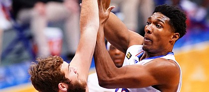 Kansas forward David McCormack (33) turns for a shot over Washburn forward Jonny Clausing (42) during the first half on Thursday, Dec. 3, 2020 at Allen Fieldhouse.