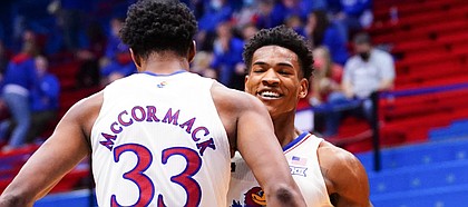 Kansas forward David McCormack (33) throws a chest bump to Kansas guard Ochai Agbaji (30) after a dunk during the second half on Friday, Dec. 11, 2020 at Allen Fieldhouse.