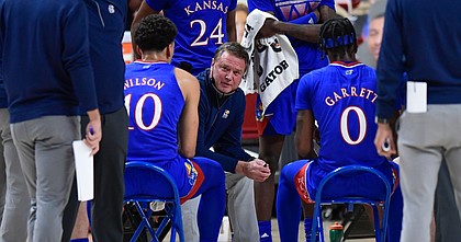 Kansas' head coach Bill Self talks to the team during in a timeout in the first half of an NCAA college basketball game against Texas Tech in Lubbock, Texas, Thursday, Dec. 17, 2020.