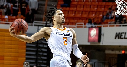 Oklahoma State's Cade Cunningham slam dunks the ball during the second half of the NCAA college basketball game against Oakland in Stillwater, Okla., Saturday, Dec. 5, 2020.
