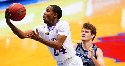 Kansas guard Bryce Thompson (24) elevates to the bucket past Washburn forward Will McKee (23) during the second half on Thursday, Dec. 3, 2020 at Allen Fieldhouse.