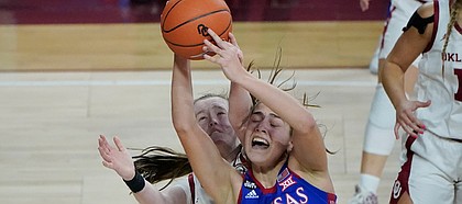 Kansas forward Ioanna Chatzileonti (11) is fouled by Oklahoma guard Taylor Robertson, left, in the second half of an NCAA college basketball game Wednesday, Jan. 27, 2021, in Norman, Okla. (AP Photo/Sue Ogrocki)