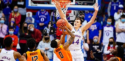 Kansas forward Mitch Lightfoot (44) gets up to block a shot from Oklahoma State guard Avery Anderson III (0) during the first half on Monday, Feb. 8, 2021 at Allen Fieldhouse.