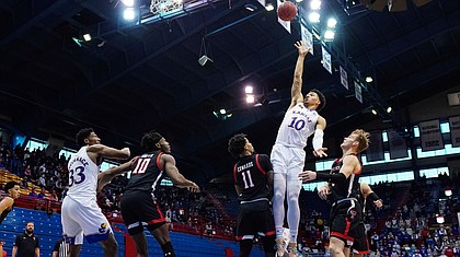 Kansas forward Jalen Wilson (10) shoots against Texas Tech guard Kyler Edwards (11) and guard Mac McClung (0) during the first half at Allen Fieldhouse Saturday afternoon in Allen Fieldhouse on Feb. 20, 2021. Photo by Jay Biggerstaff-USA TODAY Sports.