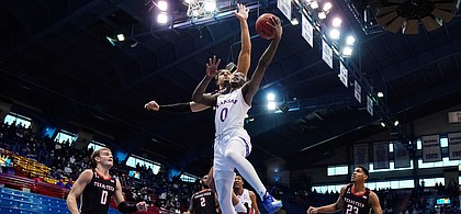 Kansas guard Marcus Garrett (0) shoots against Texas Tech guard Kevin McCullar (15) during the first half at Allen Fieldhouse Saturday afternoon in Allen Fieldhouse on Feb. 20, 2021. Photo by Jay Biggerstaff-USA TODAY Sports.
