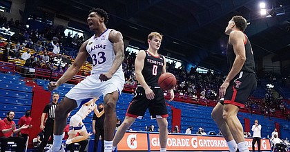 Kansas forward David McCormack (33) reacts after scoring against Texas Tech guard Mac McClung (0) and guard Kevin McCullar (15) during the first half at Allen Fieldhouse Saturday afternoon in Allen Fieldhouse on Feb. 20, 2021. Photo by Jay Biggerstaff-USA TODAY Sports.