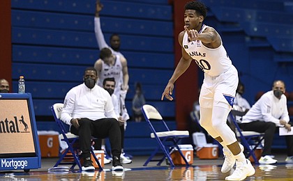 Kansas guard Ochai Agbaji points at a teammate during a game against Texas Tech Saturday afternoon in Allen Fieldhouse on Feb. 20, 2021.