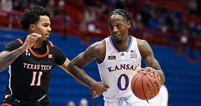 Kansas senior Marcus Garrett attempts to drive past a Texas Tech defender during a game against Texas Tech Saturday afternoon in Allen Fieldhouse on Feb. 20, 2021. Photo by Mike Gunnoe.