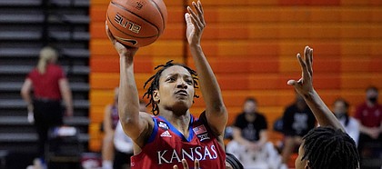 Kansas guard Aniya Thomas (5) shoots in front of Oklahoma State forward Natasha Mack (4) in the first half of an NCAA college basketball game Tuesday, Feb. 2, 2021, in Stillwater, Okla. (AP Photo/Sue Ogrocki)