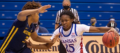 Kansas guard Zakiyah Franklin attacks off the dribble against West Virginia during the Jayhawks' home game on Feb. 27, 2021.