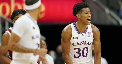 KU junior Ochai Agbaji flexes after a big bucket during KU's 69-62 win over No. 25 Oklahoma in the quarterfinals of the Big 12 tournament on Thursday, March 11, 2021 at T-Mobile Center in Kansas City, Mo.