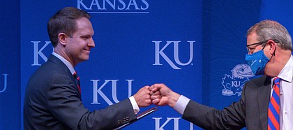 Travis Goff, a 2002 graduate of the University of Kansas and native of Dodge City, left, fist-bumps KU Chancellor Douglas Girod, right, on Wednesday, April 7, 2021, at the Lied Center on KU's west campus.