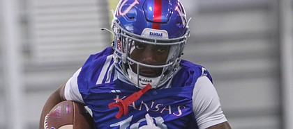 Kansas receiver Steven McBride runs through a drill during a spring practice at the Jayhawks' indoor facility on March 30, 2021.