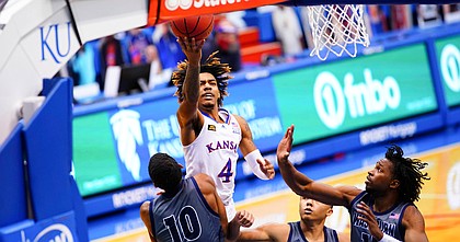 Kansas guard Latrell Jossell (4) elevates to the bucket before being called for a charge during the second half on Thursday, Dec. 3, 2020 at Allen Fieldhouse.