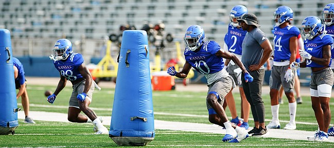 Kansas receiver Jamahl Horne (88) and Tristan Golightly look to sweep around dummies during practice on Saturday, Aug. 14, 2021 at Memorial Stadium.