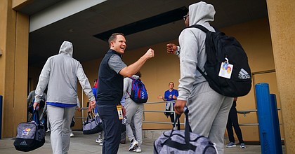 Kansas athletic director Travis Goff greets members of the football team with fist bumps as they head to the locker room prior to kickoff against South Dakota on Friday, Sept. 4, 2021 outside the Anderson Family Football Complex. (Photo by Nick Krug/Special to the Journal-World)
