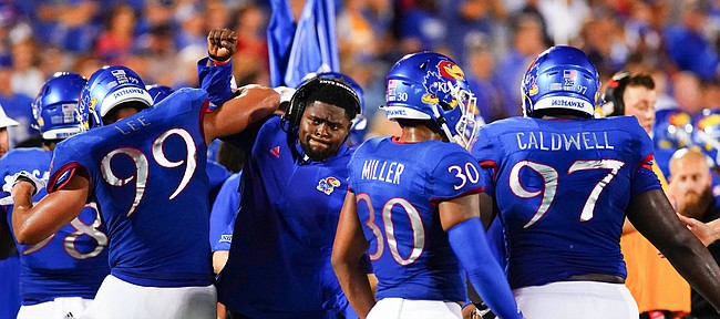 Kansas defensive line coach Kwahn Drake celebrates with Kansas defensive lineman Malcolm Lee (99) after Lee broke up a South Dakota pass deep near the goal line during the second quarter on Friday, Sept. 3, 2021 at Memorial Stadium. (Photo by Nick Krug/Special to the Journal-World)