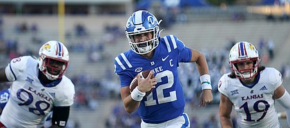 Duke quarterback Gunnar Holmberg (12) runs for a touchdown while Kansas defensive lineman Caleb Sampson (98) and linebacker Gavin Potter (19) give chase during the second half of an NCAA college football game in Durham, N.C., Saturday, Sept. 25, 2021. (AP Photo/Gerry Broome)