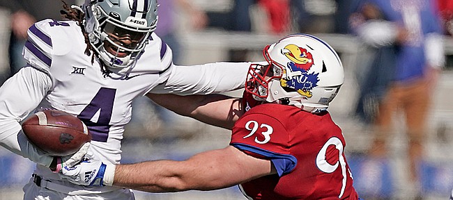 Kansas State wide receiver Malik Knowles (4) is tackled by Kansas defensive lineman Sam Burt (93) during the first half of an NCAA football basketball game against Kansas Saturday, Nov. 6, 2021, in Lawrence, Kan. (AP Photo/Charlie Riedel)