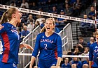 Kansas volleyball teammates Jenny Mosser, Rachel Langs and Camryn Turner celebrate after a KU point during a second-round NCAA Tournament match versus Creighton at D.J. Sokol Arena in Omaha, Neb., on Dec. 3, 2021.