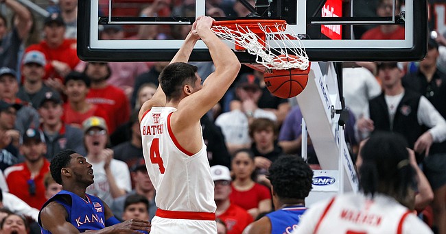 Texas Tech's Daniel Batcho (4) dunks the ball during the first half of an NCAA college basketball game against Kansas, Saturday, Jan. 8, 2022, in Lubbock, Texas. (AP Photo/Brad Tollefson)