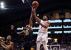 Kansas guard Joseph Yesufu (1) goes up for a shot over West Virginia guard Malik Curry (10) during the second half on Saturday, Jan. 15, 2022 at Allen Fieldhouse.