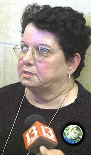 Wearing a button bearing the image of her slain daughter, Tommie Sue Arfmann meets with the media at the Jefferson County Courthouse in Oskaloosa. Floyd S. Bledsoe was sentenced to life in prison for the November 1999 murder of his 14-year-old sister-in-law, Camille Arfmann.