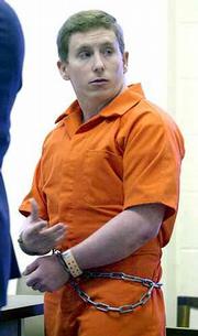 At his sentencing for the November 1999 murder of his sister-in-law, Camille Arfmann, Floyd S. Bledsoe, 23, gestures toward his wife, sister of his victim. Bledsoe was sentenced Friday in the Jefferson County Courthouse in Oskaloosa to life in prison for the crime.
